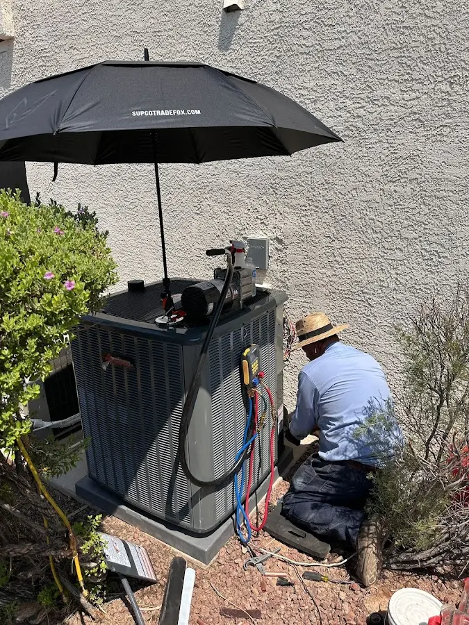HVAC technician performing outdoor AC maintenance in Mendon